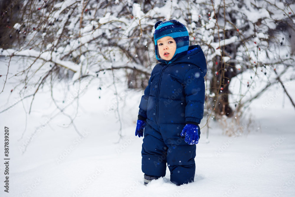 little boy walking on snow in winter outdoors little boy walking on snow in winter outdoors