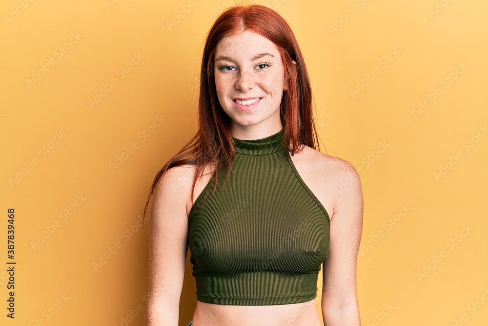 Young red head girl wearing casual clothes with a happy and cool smile on face. lucky person. Young red head girl wearing casual clothes with a happy and cool smile on face. lucky person.