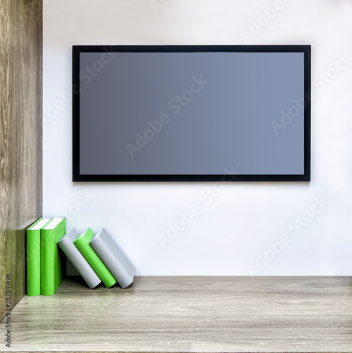 Background in pastel colors with free space for your label or ad.A TV panel on the wall and a stack of books on a shelf. Minimalistic composition.