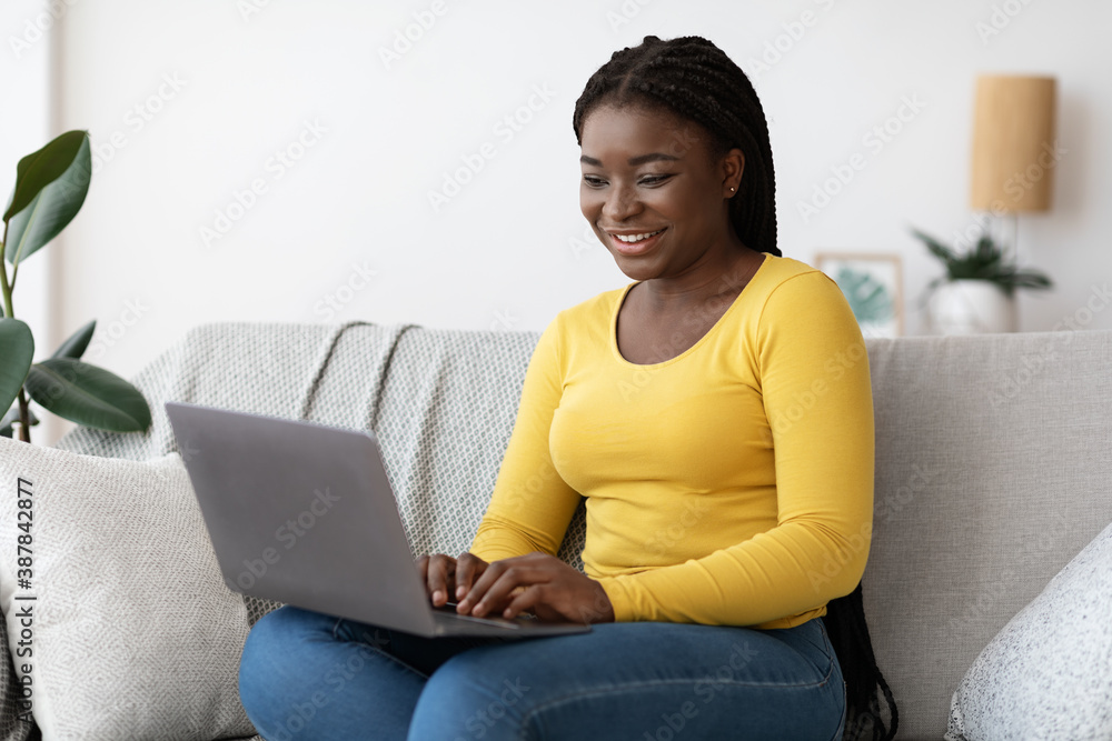 Remote Work. Cheerful Black Millennial Woman Using Laptop Computer At Home Remote Work. Cheerful Black Millennial Woman Using Laptop Computer At Home