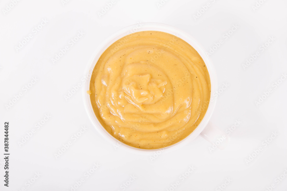 Pumpkin soup in a bowl on a white background Pumpkin soup in a bowl on a white background