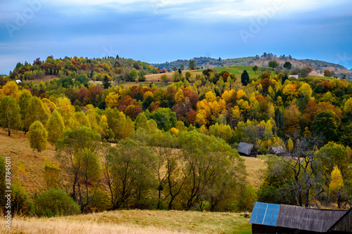 Colorful autumn landscape in the Romanian Carpathians, Fantanele village, Sibiu county, Cindrel mountains, 1100m, Romania photo