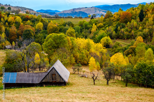 Colorful autumn landscape in the Romanian Carpathians, Fantanele village, Sibiu county, Cindrel mountains, 1100m, Romania photo