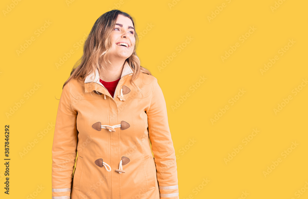 Young caucasian woman wearing casual clothes looking away to side with smile on face, natural expression. laughing confident. Young caucasian woman wearing casual clothes looking away to side with smile on face, natural expression. laughing confident.