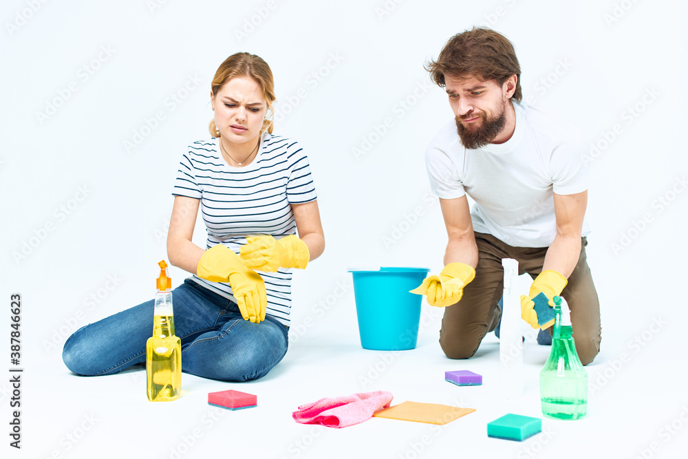 Young couple wash floors at home interior light background lifestyle Young couple wash floors at home interior light background lifestyle