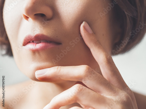 Close up portrait of woman on white background. Natural beauty without make up.