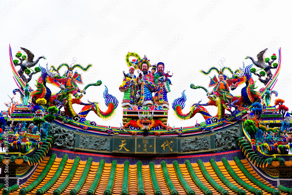 Tainan, Taiwan, October 12, 2019 Colorful roofs of a Taiwanese temple decorated with sculptures of sacred animals, dragons, lions and deities in traditional mosaic art Tainan, Taiwan, October 12, 2019 Colorful roofs of a Taiwanese temple decorated with sculptures of sacred animals, dragons, lions and deities in traditional mosaic art