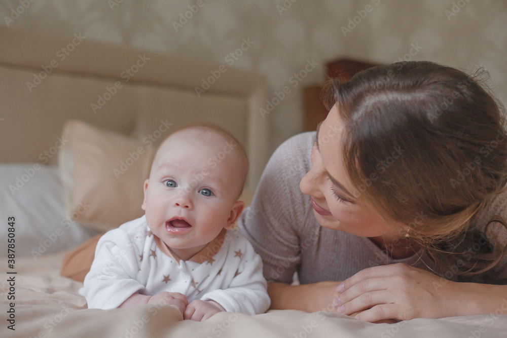Mother holding infant baby, take care of her 3 months old child at home bedroom . Happy mom carying of her newborn son . Mum love little baby Mother holding infant baby, take care of her 3 months old child at home bedroom . Happy mom carying of her newborn son . Mum love little baby