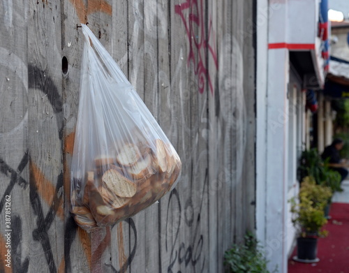 A bag of old bread for the poor hangs on a fence on Abdul Ezel Pasha street in Istanbul. Turkey © b201735