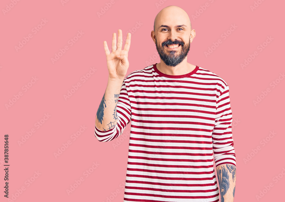 Young handsome man wearing casual clothes showing and pointing up with fingers number four while smiling confident and happy. Young handsome man wearing casual clothes showing and pointing up with fingers number four while smiling confident and happy.