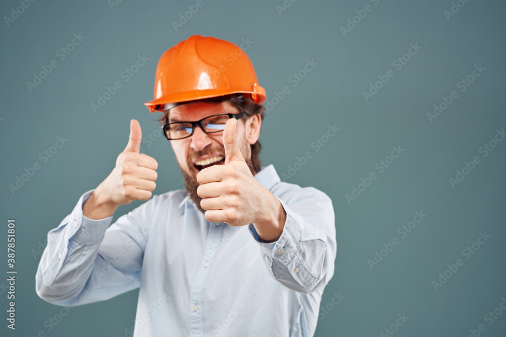 Cheerful man in orange hard hat shirt gesturing with hands work construction engineer Cheerful man in orange hard hat shirt gesturing with hands work construction engineer