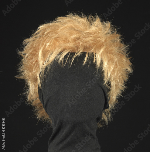 Wavy blonde hair wig, black background
