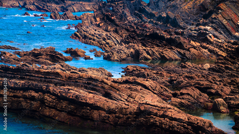 rocky coast of the sea with rocks surrounded by water