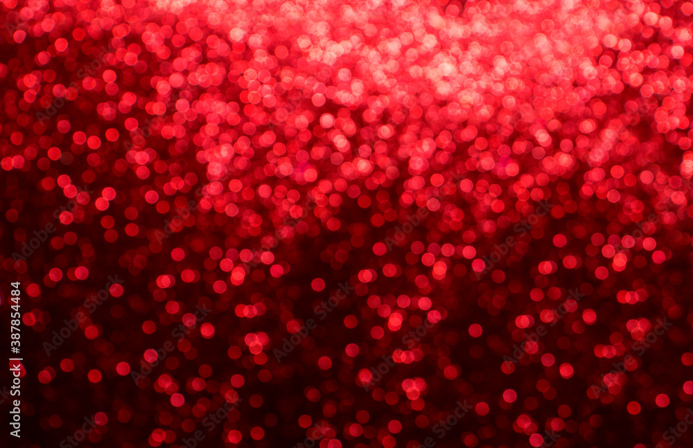 Christmas background with red bokeh lights in defocus. Romantic festive abstract blurred background.
