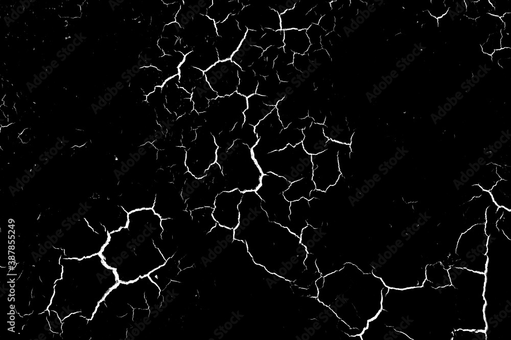 Grunge black and white pattern. Abstract texture of monochrome particles. Black background with white cracks, scuffs, chips