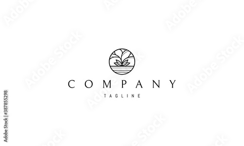 Vector logo on which an abstract image of a tree on a lake in a circle.