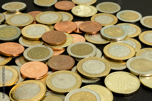 Different argentine coins stacked. Pile of money. Metal coins texture. Financial world background.