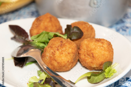 Fried Breaded Balls in the Plate With Salad Leafs