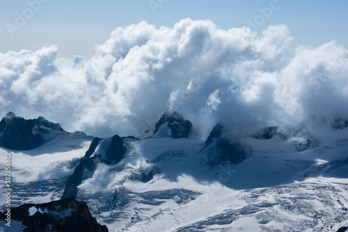 Beautiful blue morning landscape with clouds over alps in Mont Blanc massif from Aiguille du Midi 3842m, Chamonix, France photo