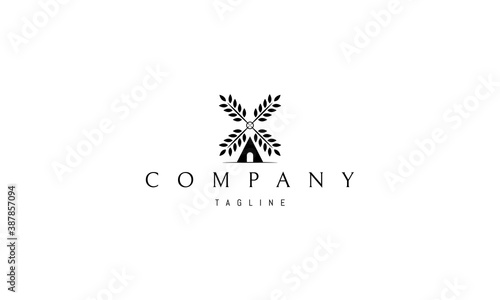 Vector logo on which an abstract image of a mill with blades in the form of wheat.