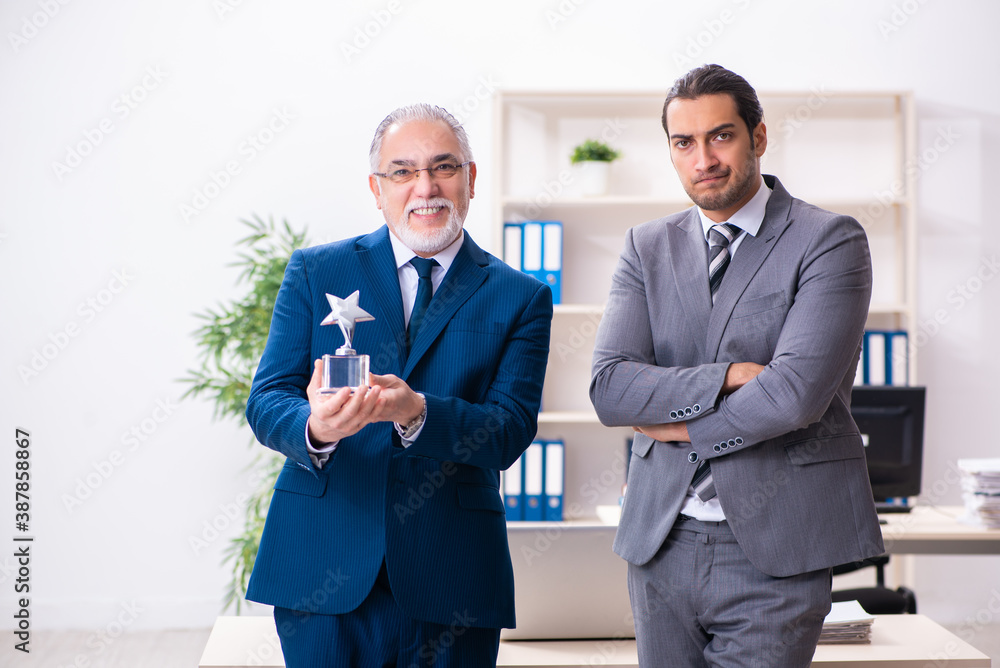 Two male employees working in the office Two male employees working in the office