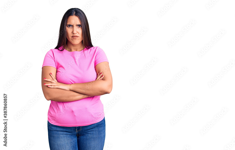 Young beautiful brunette woman wearing casual t-shirt skeptic and nervous, disapproving expression on face with crossed arms. negative person.