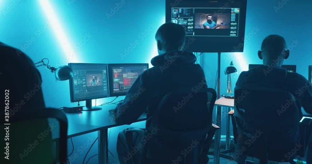 Group of hackers working on computers