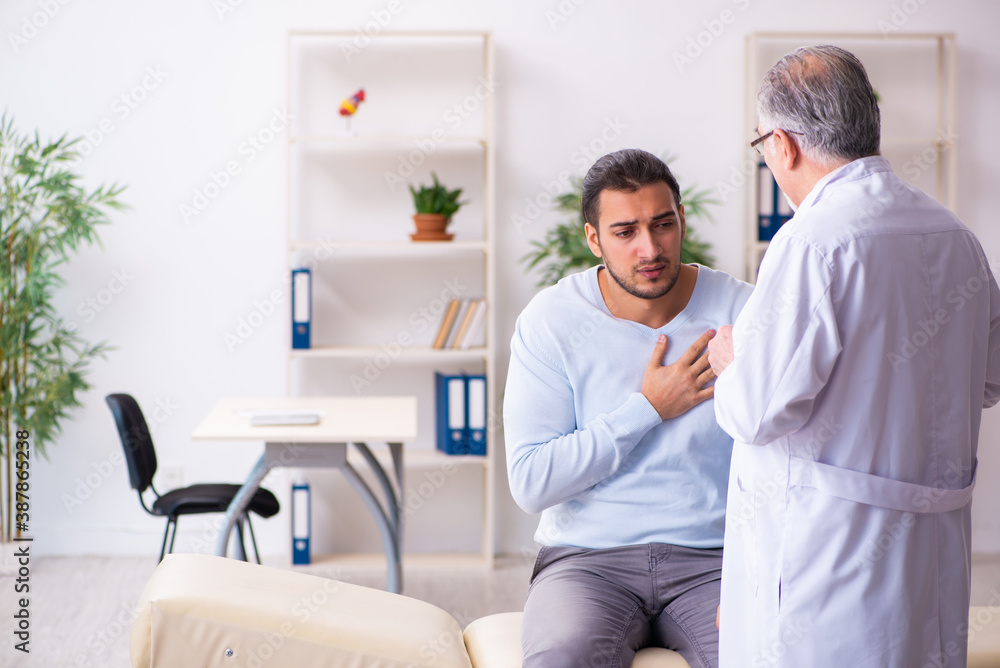 Young sick man visiting old doctor