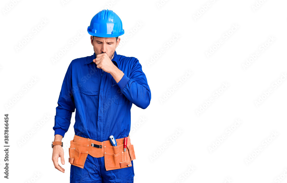 Young handsome man wearing worker uniform and hardhat with hand on stomach because indigestion, painful illness feeling unwell. ache concept. Young handsome man wearing worker uniform and hardhat with hand on stomach because indigestion, painful illness feeling unwell. ache concept.