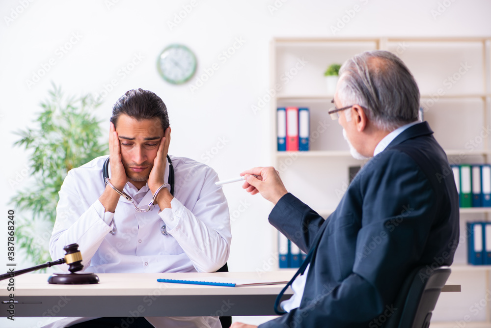 Male doctor in courthouse meeting with lawyer Male doctor in courthouse meeting with lawyer
