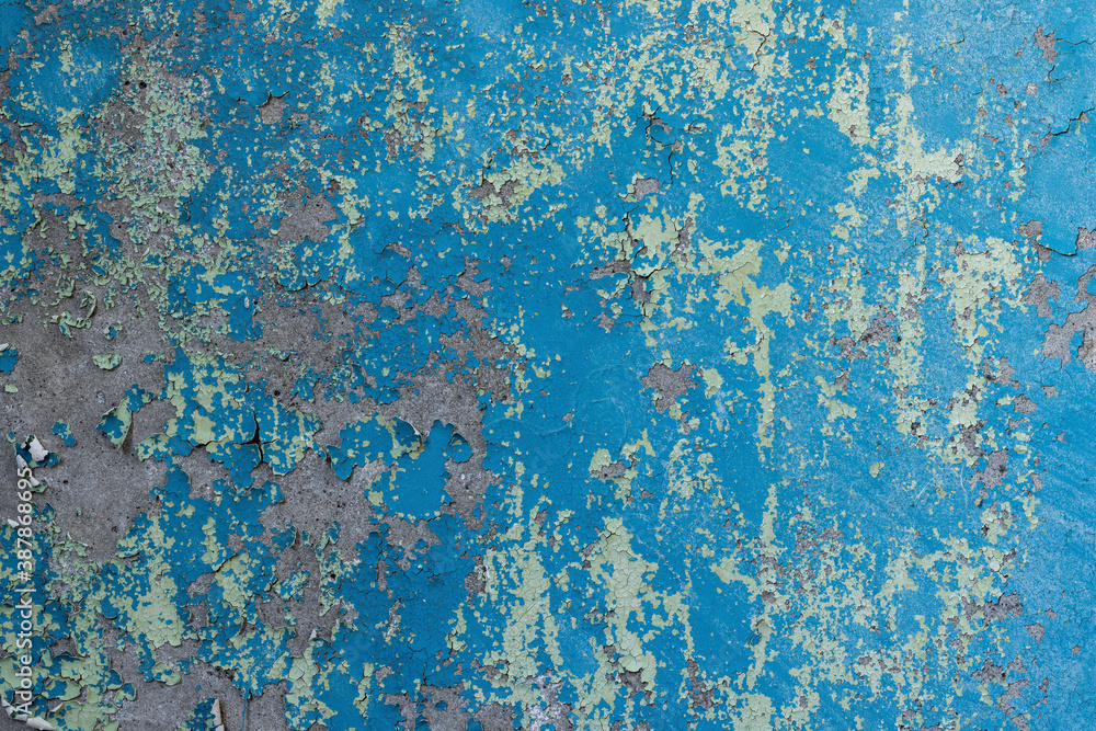 Peeling paint on the wall. Old concrete wall with cracked flaking paint. Weathered rough painted surface with patterns of cracks and peeling. Grunge texture for background and design. High resolution. Peeling paint on the wall. Old concrete wall with cracked flaking paint. Weathered rough painted surface with patterns of cracks and peeling. Grunge texture for background and design. High resolution.