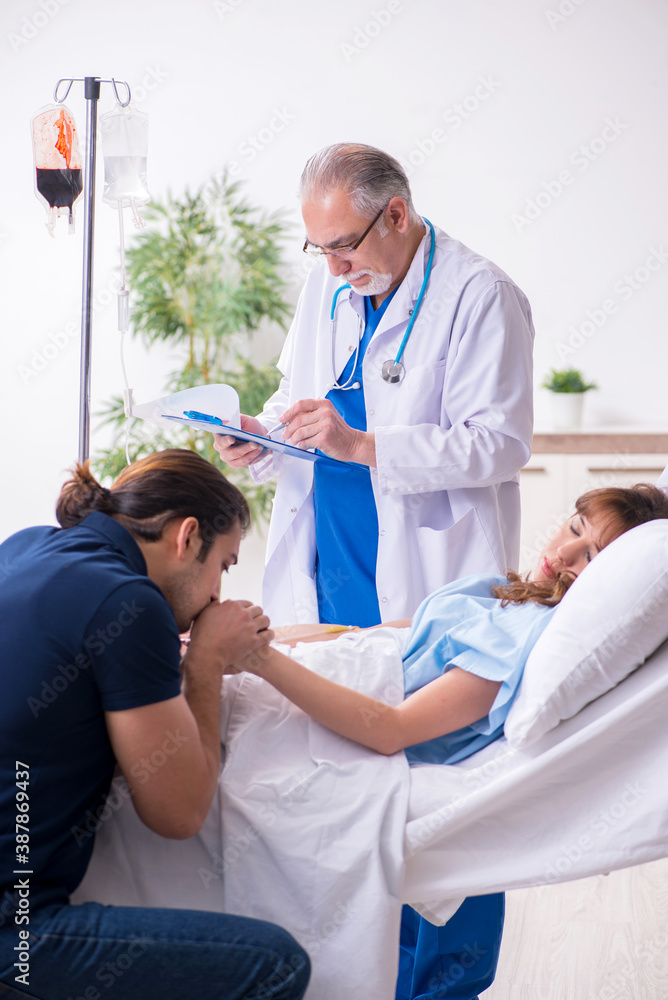 Young husband visiting sick wife in the clinic Young husband visiting sick wife in the clinic