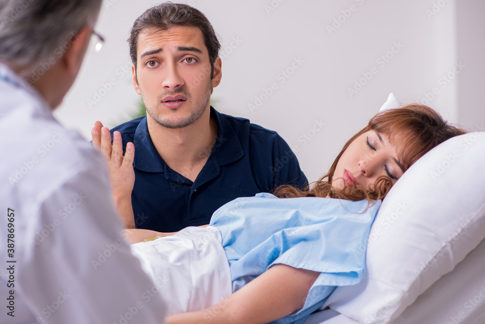 Young husband visiting sick wife in the clinic Young husband visiting sick wife in the clinic