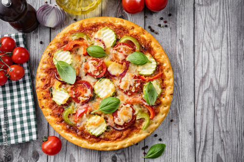 Close up of crispy vegetarian pizza on rustic wooden background
