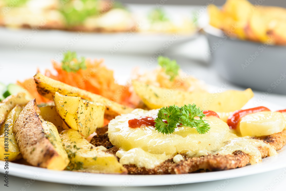 cutlet with pineapple and baked potatoes with bouquet of salads cutlet with pineapple and baked potatoes with bouquet of salads
