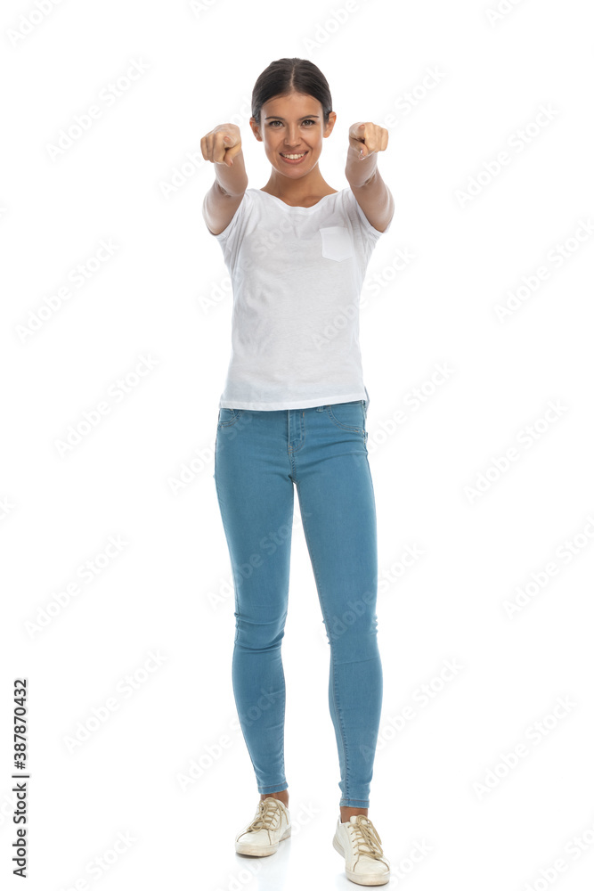 Positive casual woman pointing forward with both hands Positive casual woman pointing forward with both hands