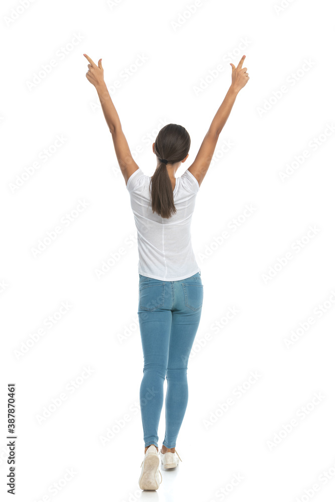 Back view of celebrating casual woman pointing up, Back view of celebrating casual woman pointing up,
