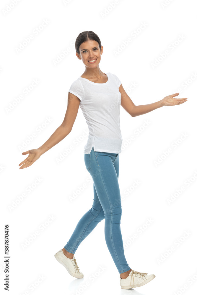Positive casual woman greeting and inviting, walking Positive casual woman greeting and inviting, walking