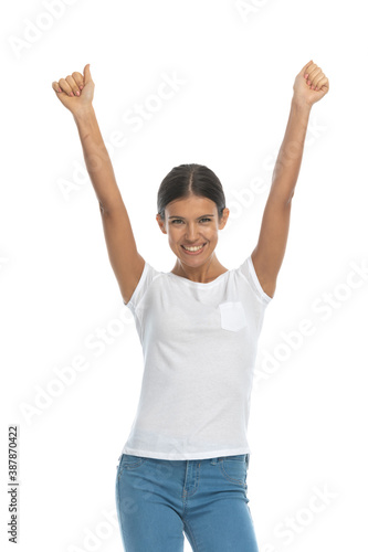 Cheerful casual woman celebrating and laughing