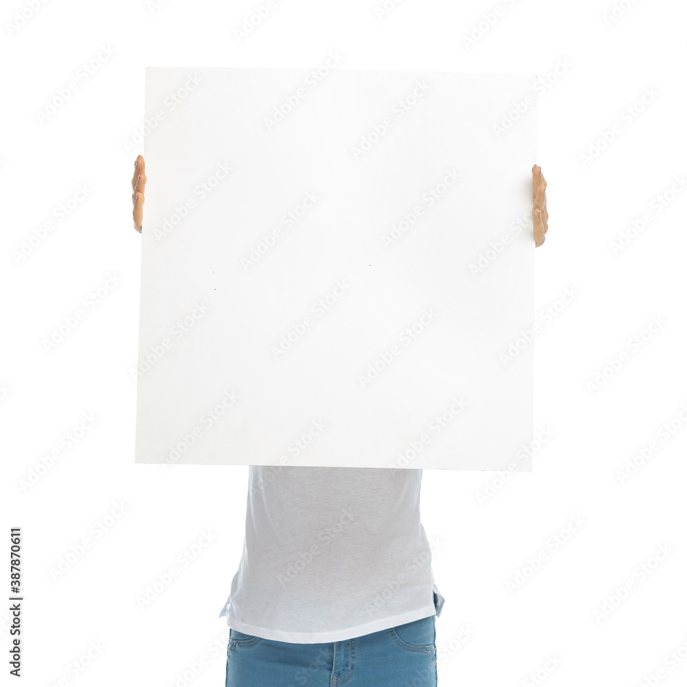 Young casual woman covering her face with blank billboard Young casual woman covering her face with blank billboard