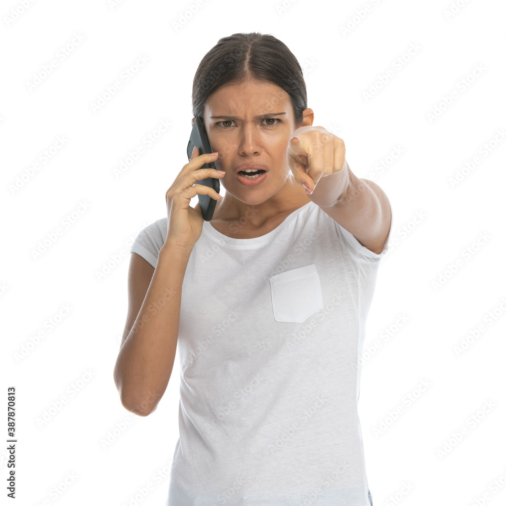 Angry casual woman talking on phone and pointing Angry casual woman talking on phone and pointing