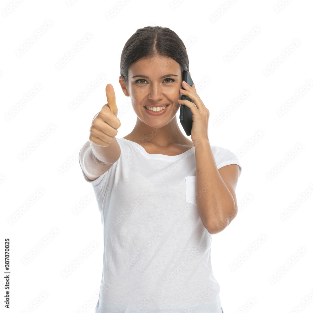 Positive casual woman talking on phone and gesturing ok Positive casual woman talking on phone and gesturing ok