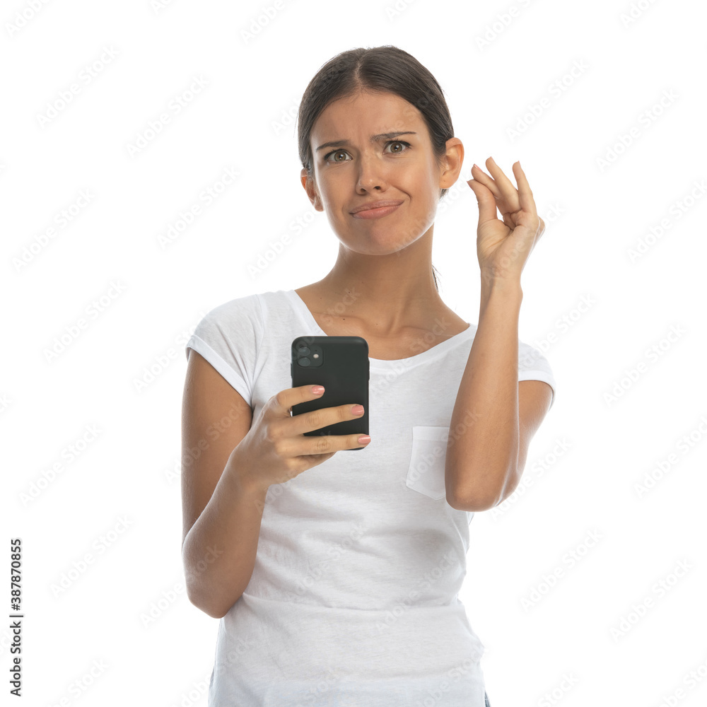 Bothered casual woman gesturing gossip and holding phone Bothered casual woman gesturing gossip and holding phone