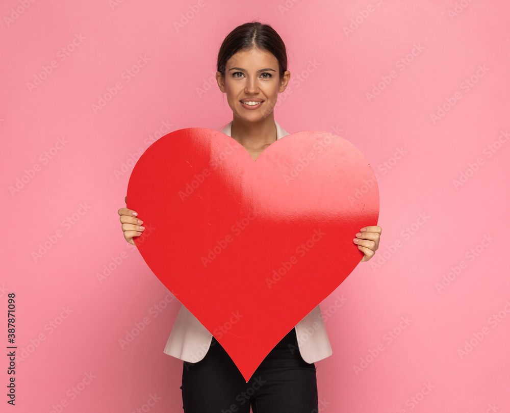 businesswoman holding a big red heart in her hands businesswoman holding a big red heart in her hands