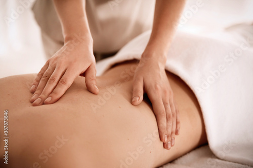Young woman receiving back massage in spa salon  closeup