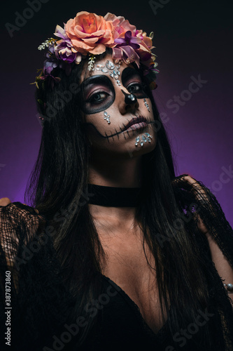 Purple color mexican skull, also known as Catrina, typical costume from Dia de los Muertos in Mexico, shot in purple color studio