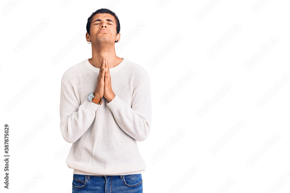 Young african amercian man wearing casual clothes begging and praying with hands together with hope expression on face very emotional and worried. begging. Young african amercian man wearing casual clothes begging and praying with hands together with hope expression on face very emotional and worried. begging.