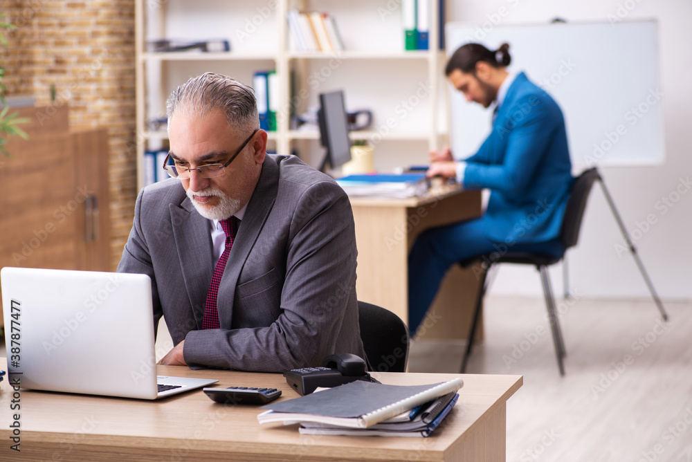 Two male colleagues working in the office Two male colleagues working in the office