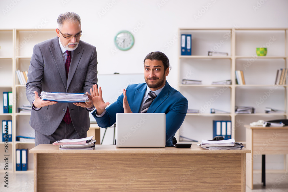 Two male colleagues working in the office Two male colleagues working in the office