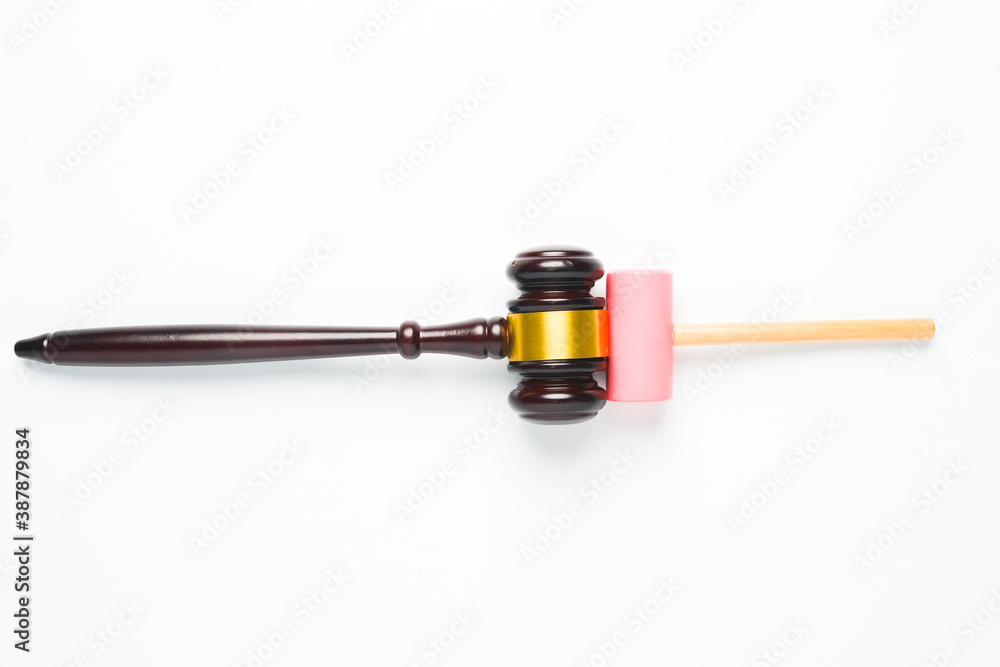 A flatlay picture of gavel and toy hammer on copyspace white background for ambition concept. The ambition of this kid to be a law judge. A flatlay picture of gavel and toy hammer on copyspace white background for ambition concept. The ambition of this kid to be a law judge.